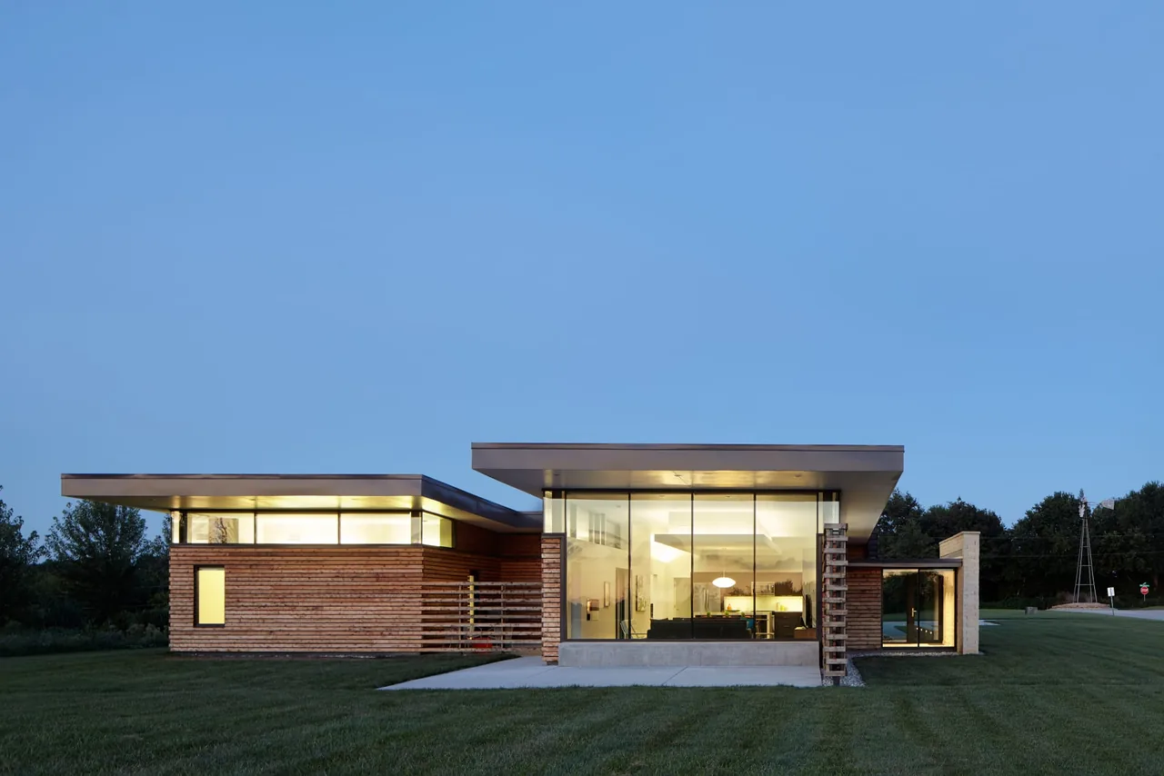 Byers Residence features a horizontal contemporary design with extensive glass walls and wood siding under flat roofs.
