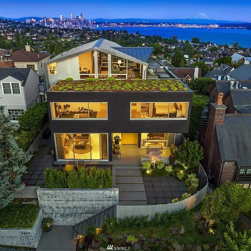 CRESTMONT by Spore Architecture features a green roof and large windows with views of the Seattle skyline and water.
