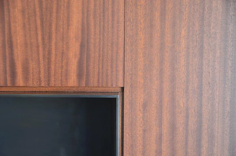 Detail of vertical wood paneling contrasted by a black rectangular inset.