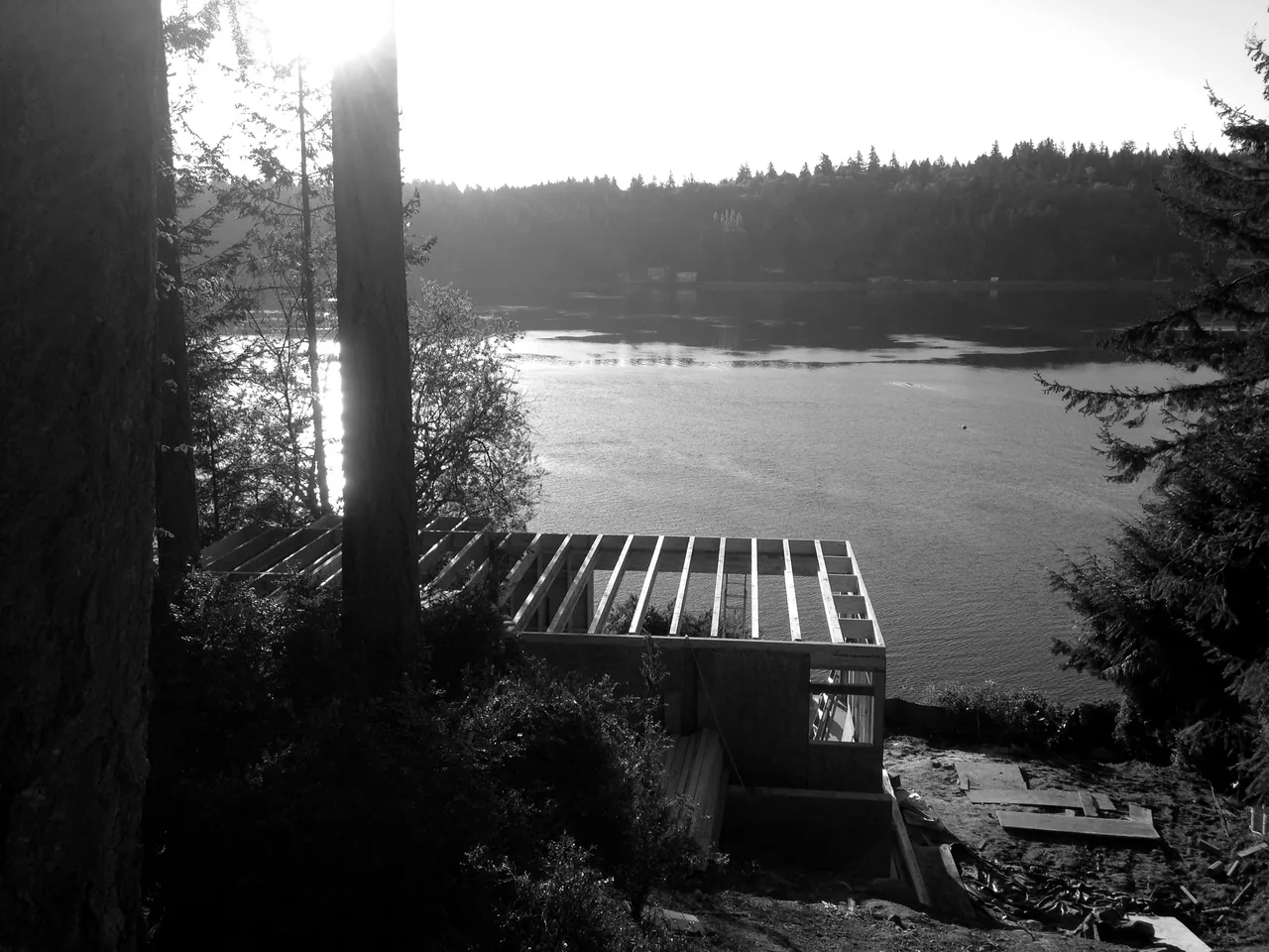 Herron Island Cabin under construction on a lakefront site with a view across the water.
