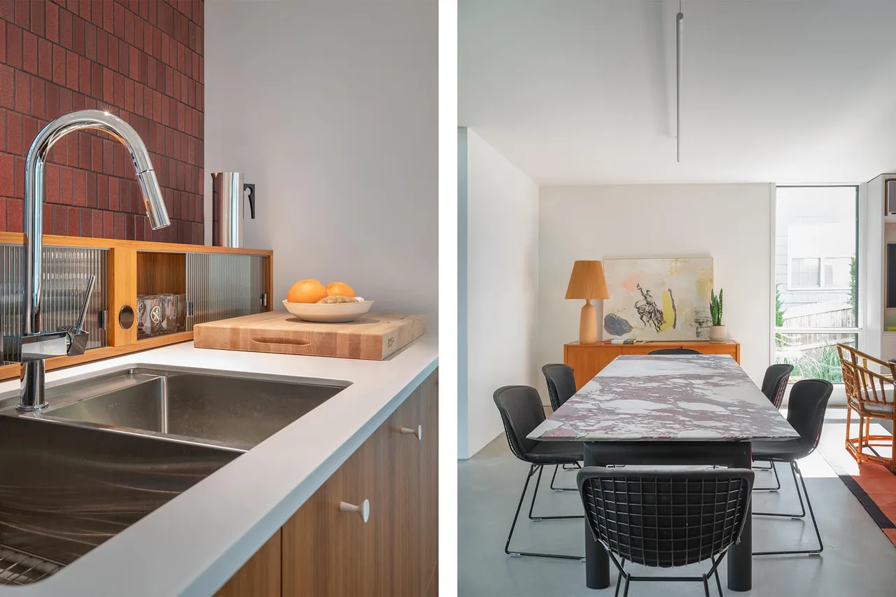 Kitchen sink area and dining space with marble table and black chairs in a modern home.