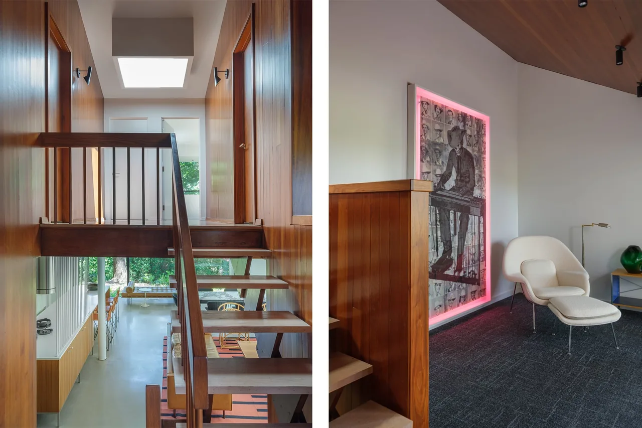 The image features a modern open-riser staircase with wood paneling and a skylight, with a cozy seating area and illuminated artwork nearby.
