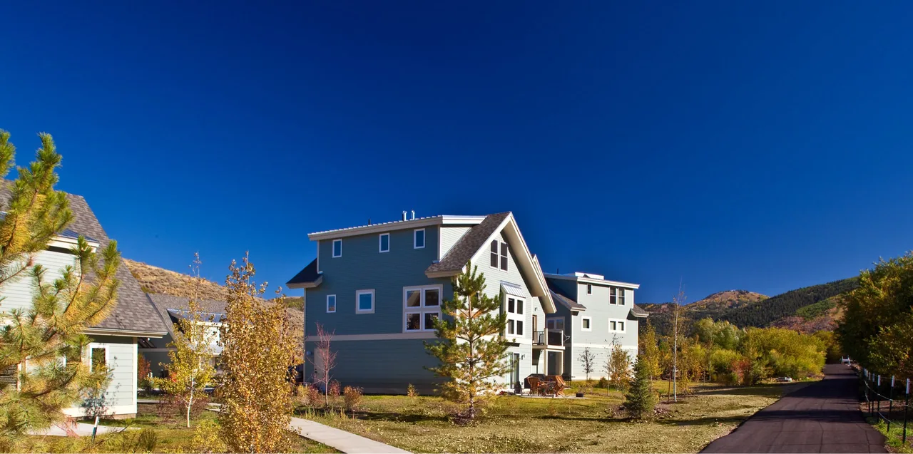 Snow Creek Cottages feature multi-story homes with gable roofs and green wood siding in a rural setting.