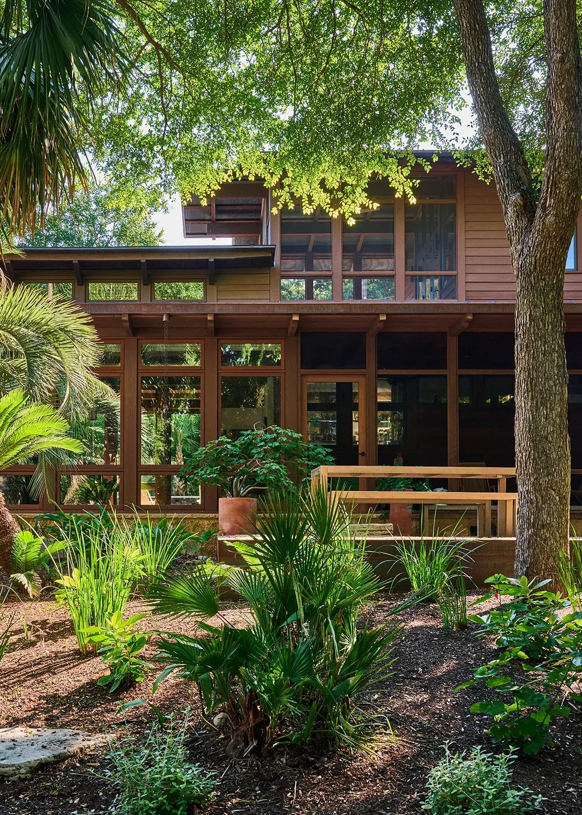 FOOTHILL TERRACE features large wood-framed windows and a landscaped garden.