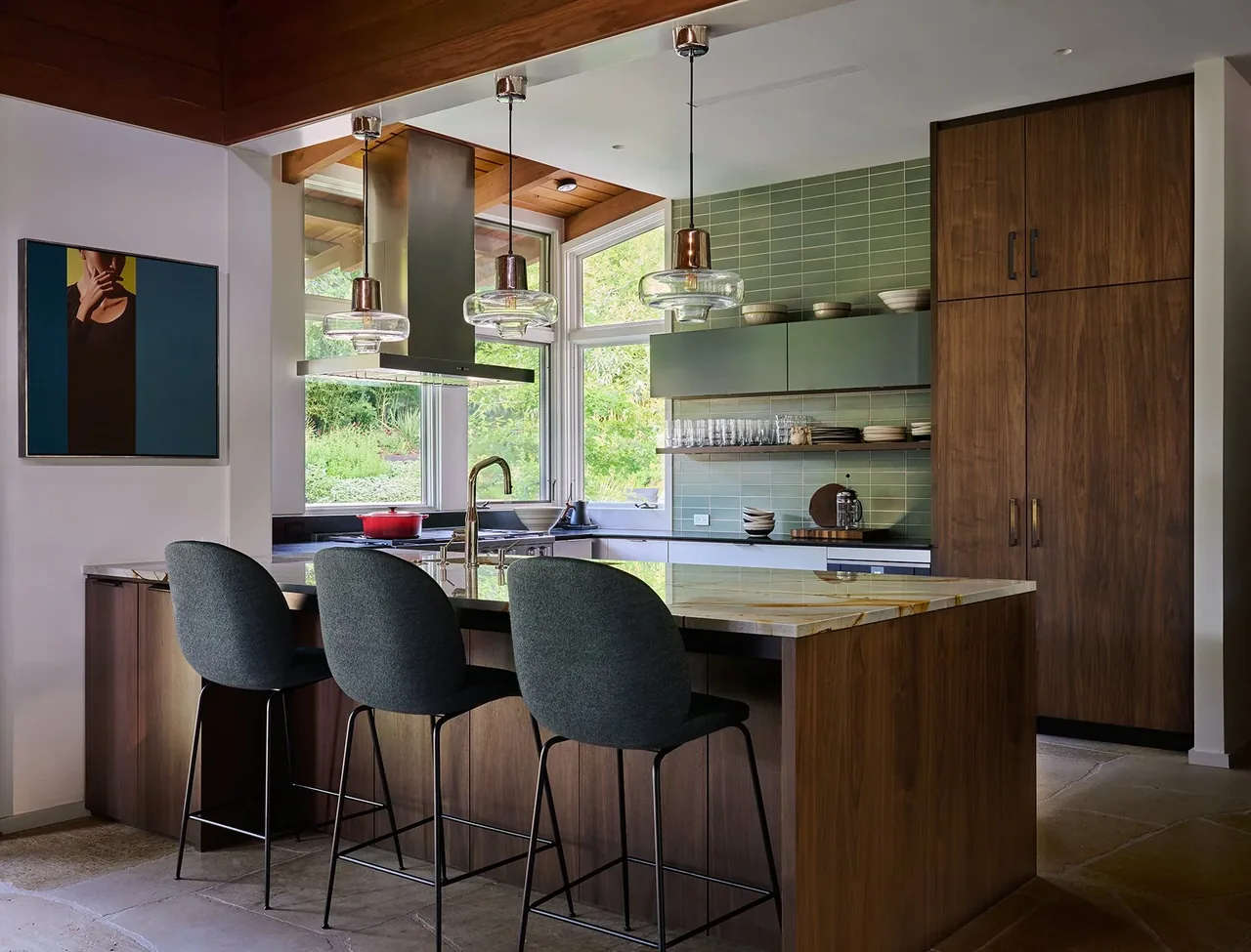 The FOOTHILL TERRACE kitchen features wood cabinets, green tile backsplash, and a marble island with pendant lighting.