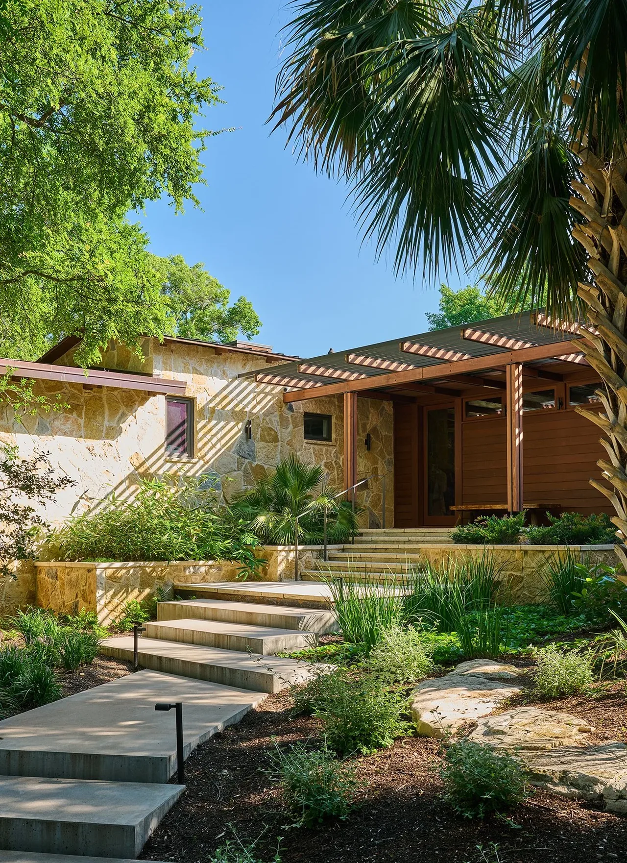 The FOOTHILL TERRACE project features a natural stone exterior and wooden pergola entry by Furman + Keil Architects.
