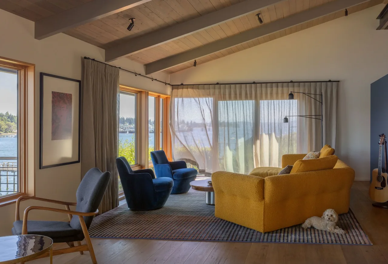Eagle Harbor Residence living room with vaulted wood ceiling and floor-to-ceiling glazing showing waterfront views.