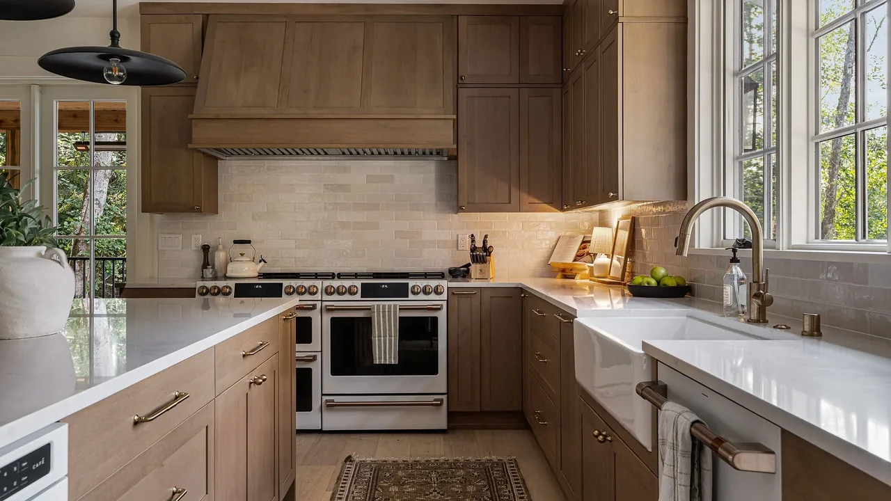 Kitchen in Cougar Mt Custom by H2D architecture + design with wood cabinets and farmhouse sink under a window.