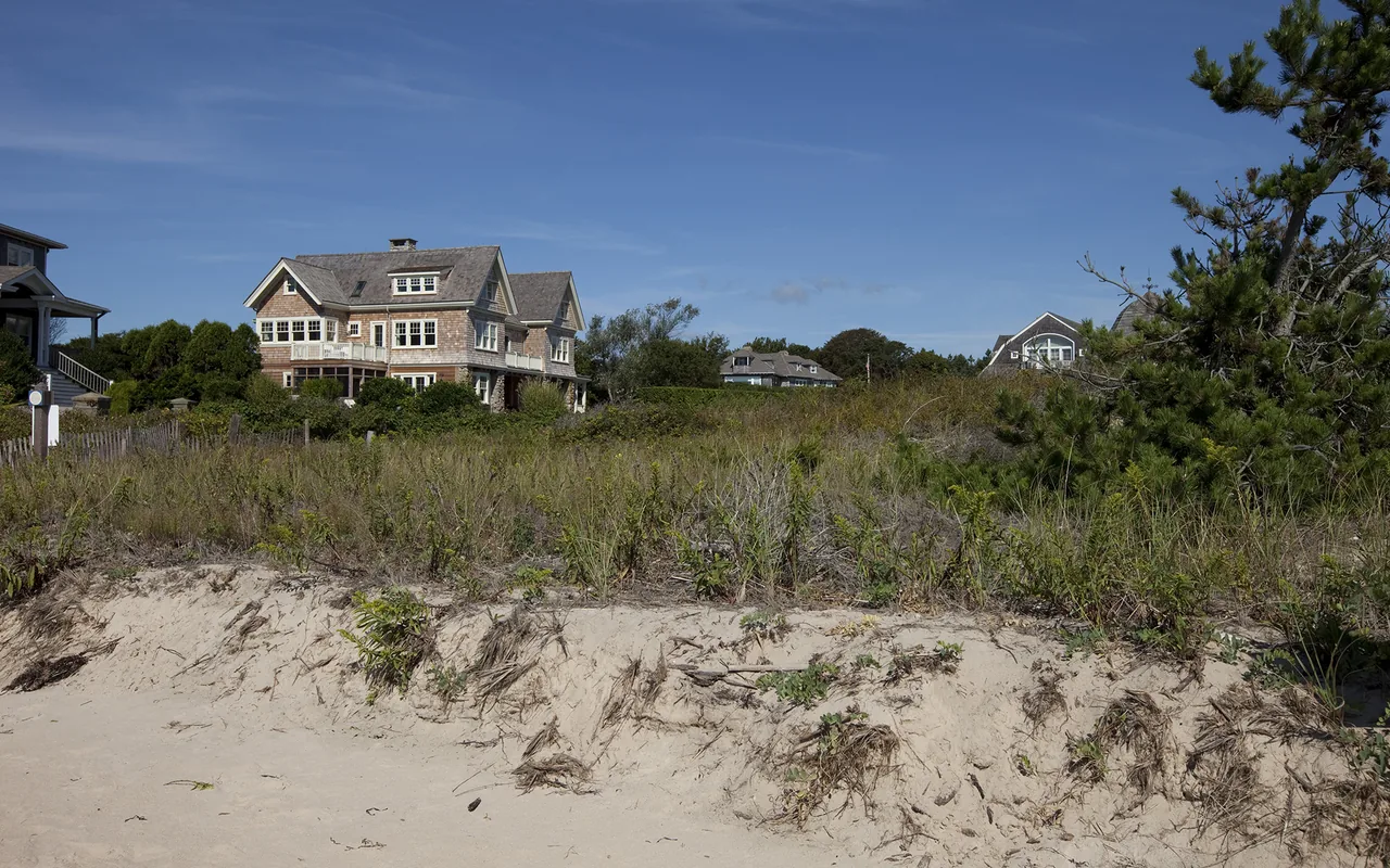 Watch Hill Rhode Island Residence features a traditional shingle-style exterior with multiple gable roofs.
