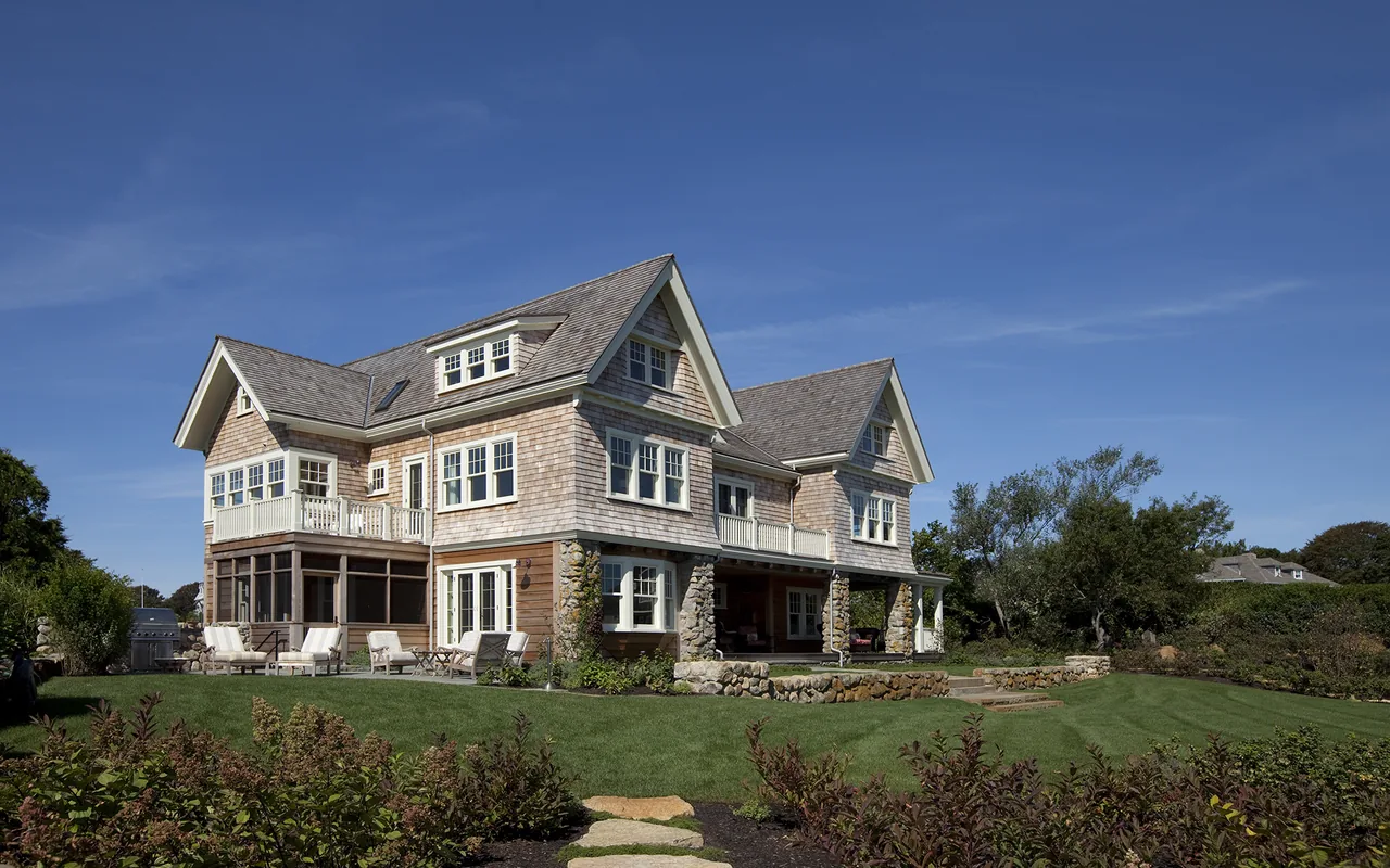 Exterior rear view of Watch Hill Rhode Island Residence featuring classic shingle siding and multiple gable roofs.