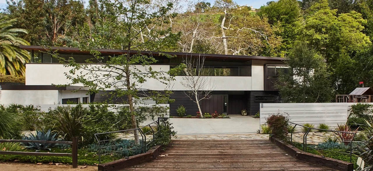 The Tree House project features a modern two-story design with flat roof and natural landscaping in Los Angeles.