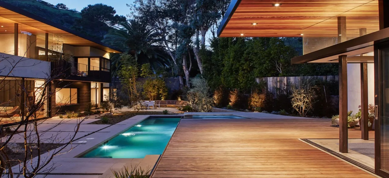 The Tree House project shows a modern two-story facade with a wooden deck and illuminated pool at dusk.