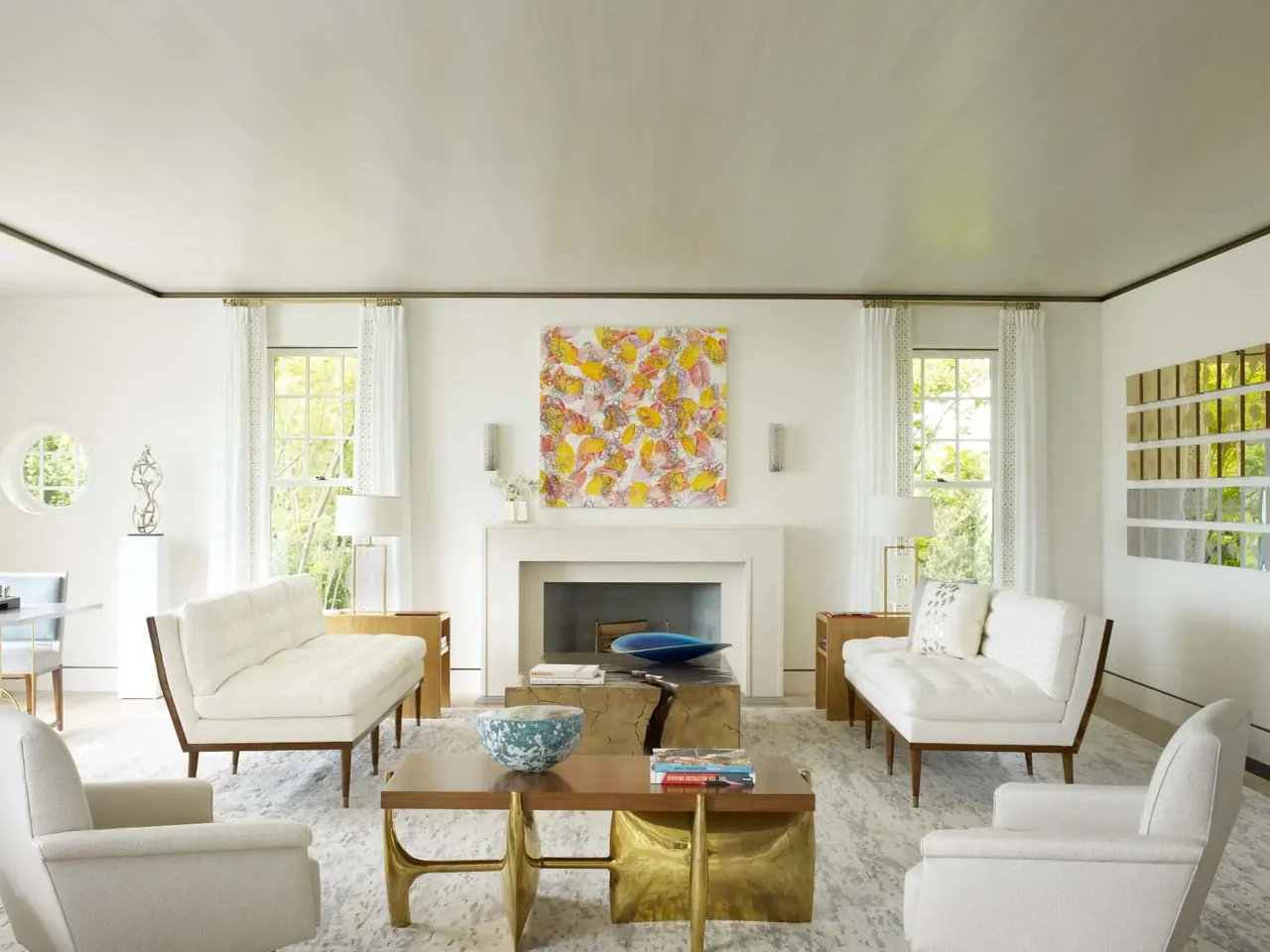Sagaponack Beach Front Hideaway living room with symmetrical seating and abstract art above the fireplace.