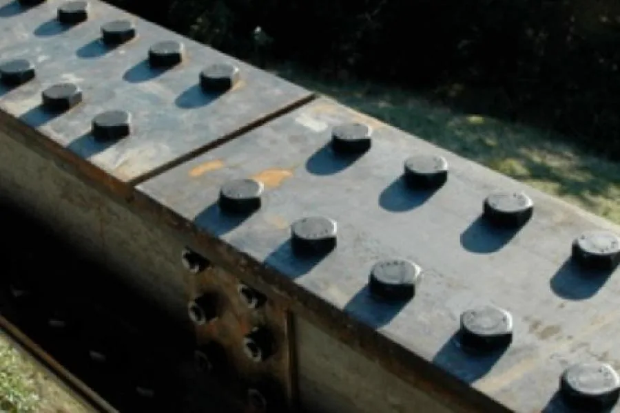 Detail of a steel beam with bolts, possibly part of the structure at Buck Mountain Weekend project.