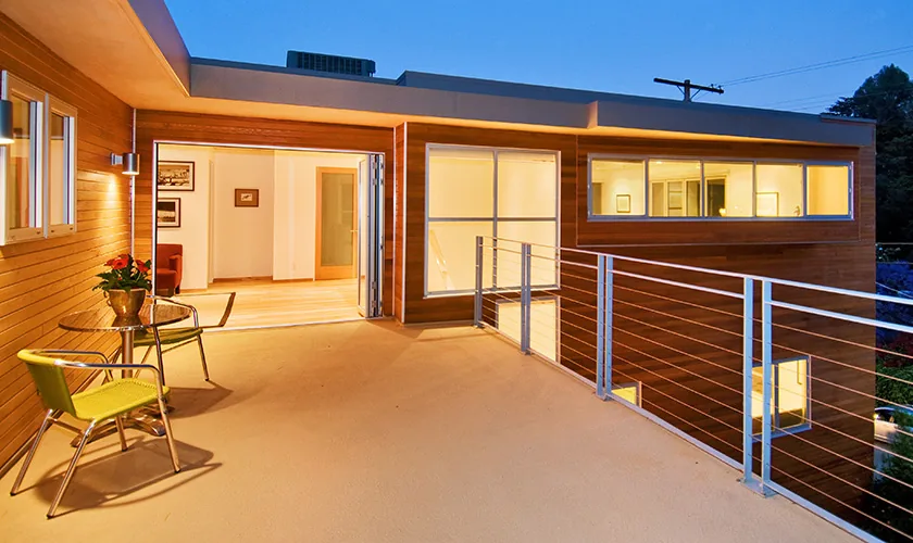 RIDPATH project features a flat roof wood-siding balcony with metal cable railing and large glass doors.