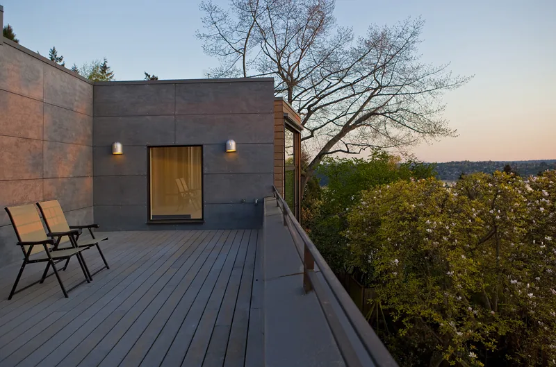 The Mercer Island Remodel features a large exterior deck with seating and expansive natural views.