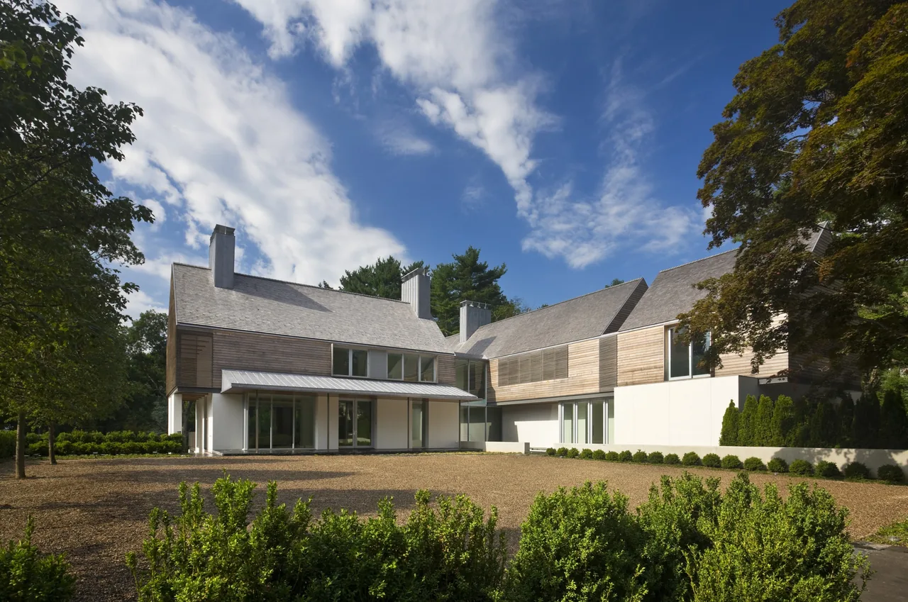 44PL project features a modern two-story home with gable roofs and horizontal wood siding cladding by Joeb + Partners, Architects.