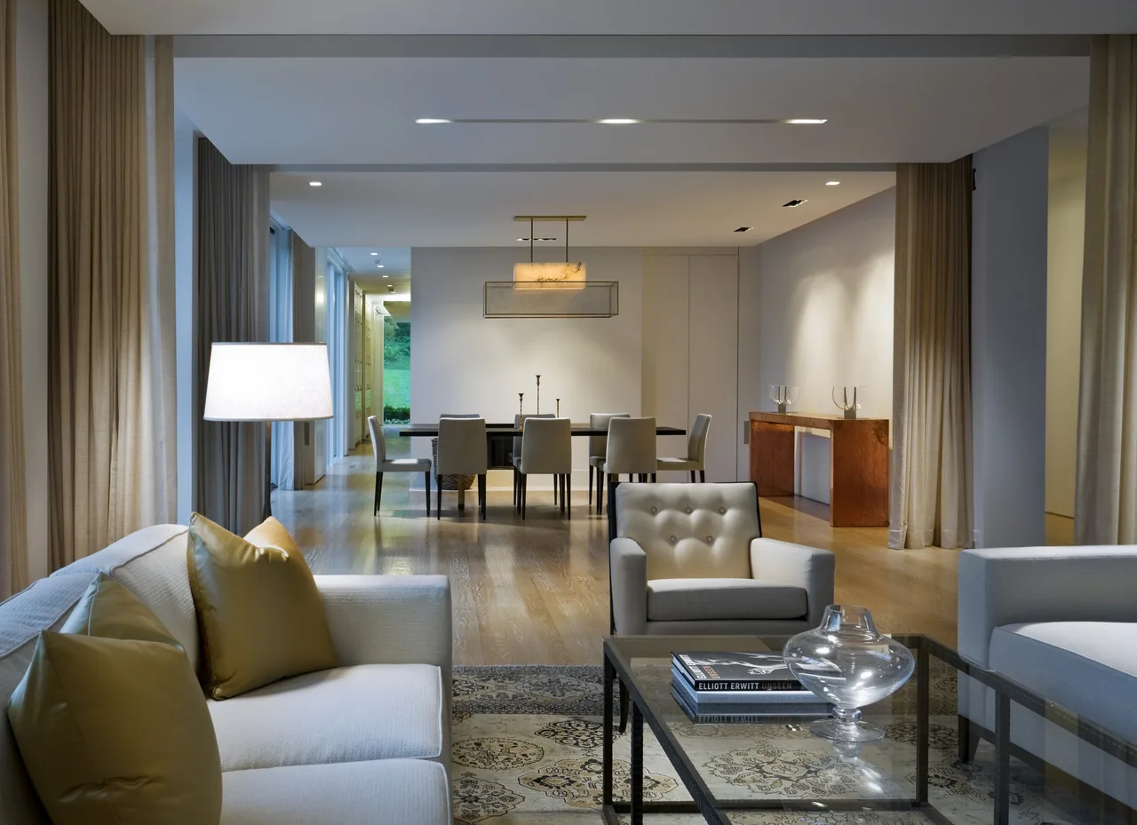 Open layout living and dining space with neutral tones and hardwood flooring in the 44PL project.