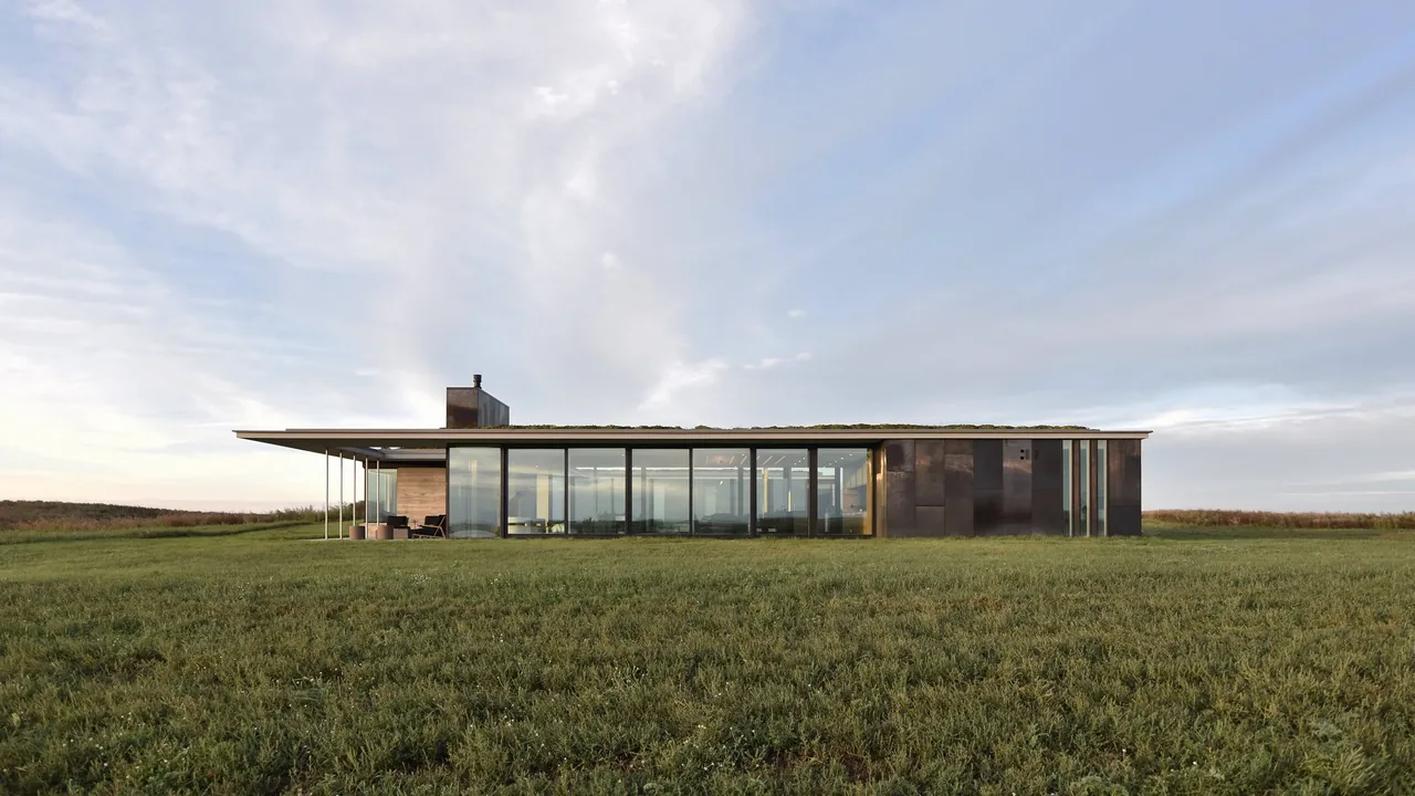 Spoonbill Ranch by Johnsen Schmaling Architects features a modern single-story design with extensive glazing and a green roof.