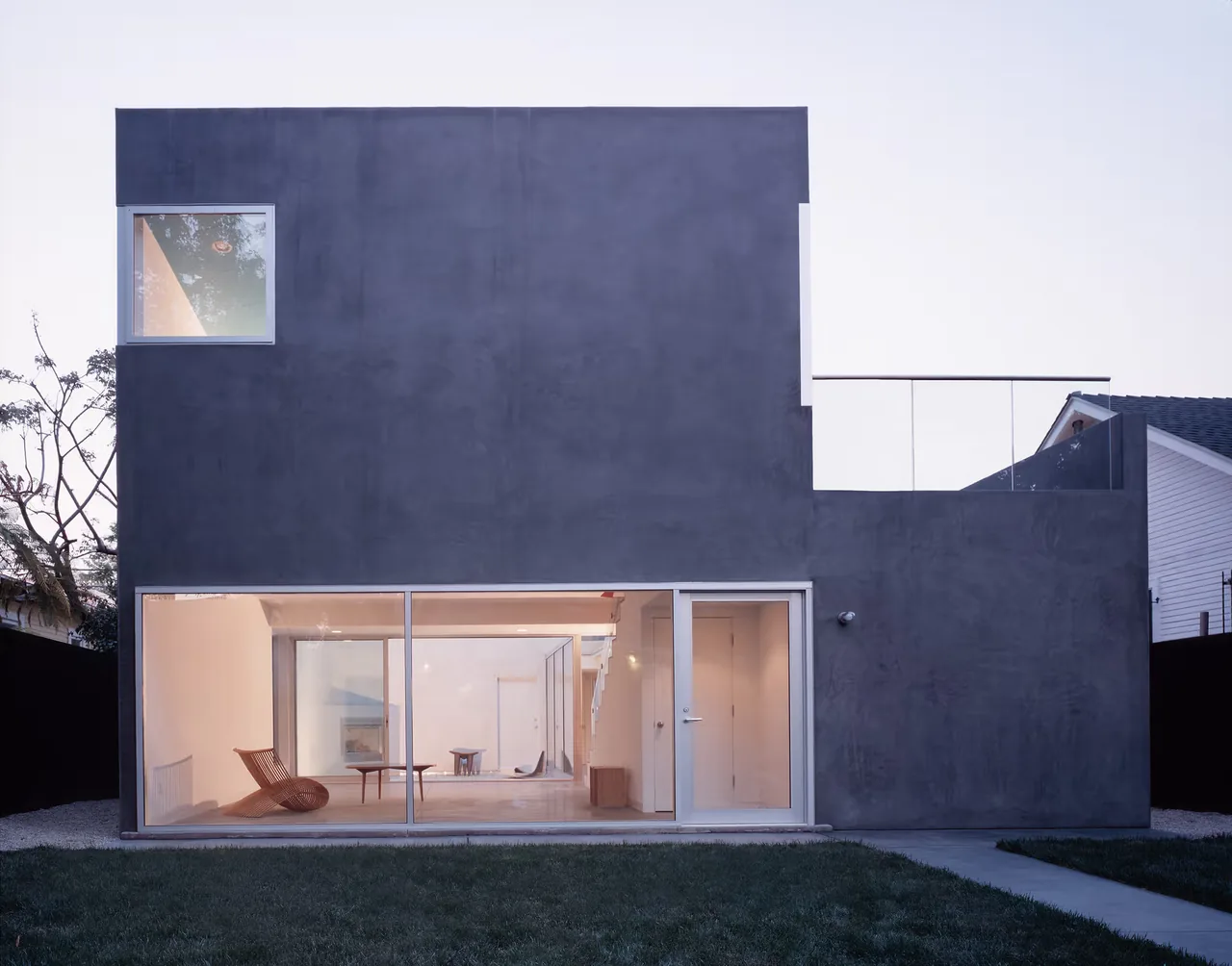 Sale House by Johnston Marklee features a modern concrete exterior with expansive glazing and a rooftop balcony in Los Angeles.