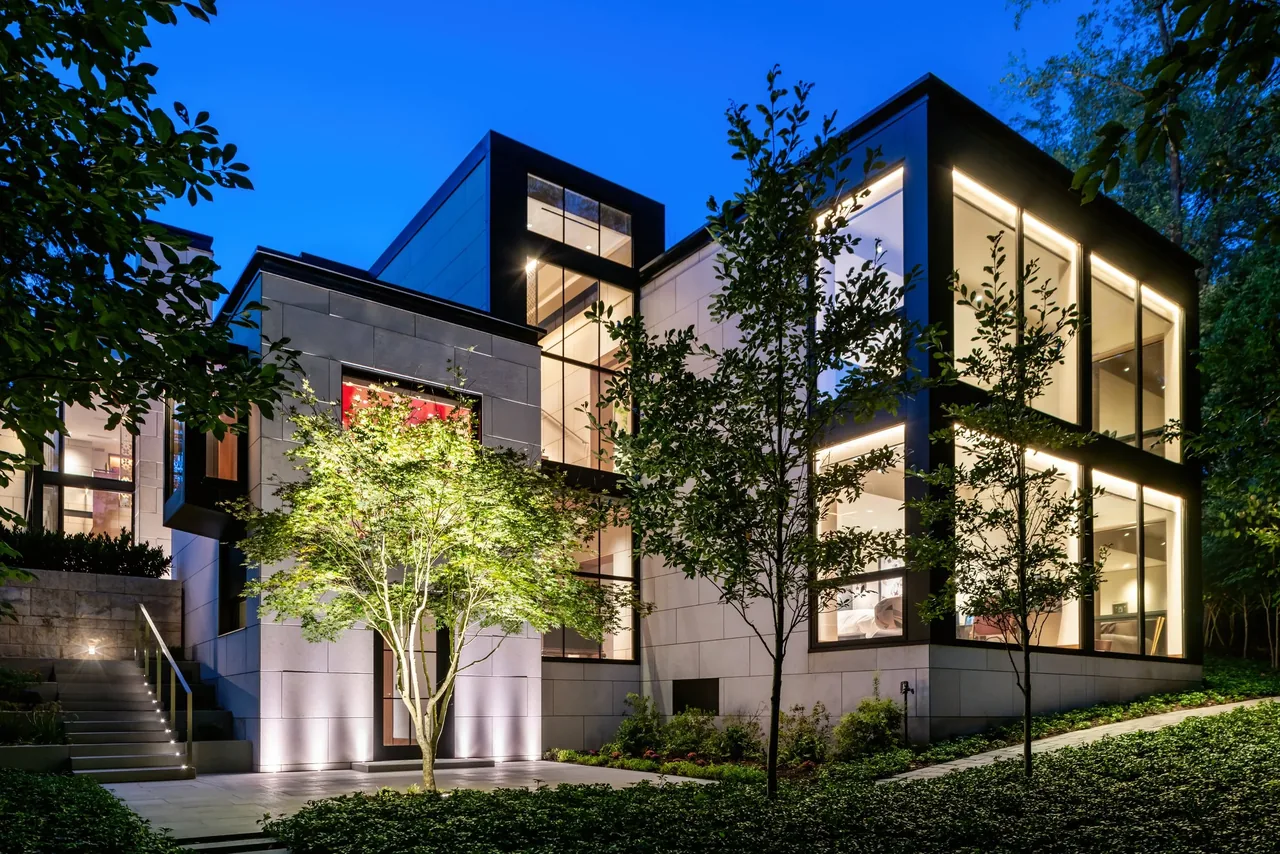 Villa Virginia features a modern two-story exterior with expansive floor-to-ceiling glazing and integrated landscape lighting.