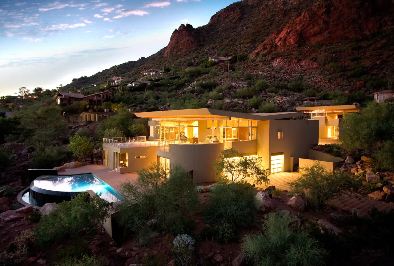 Monks Shadow Residence by Kendle Design Collaborative features flat angled roofs and hillside integration.
