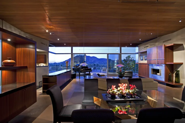 Monks Shadow Residence features a spacious living and dining room with floor-to-ceiling glazing offering mountain views.