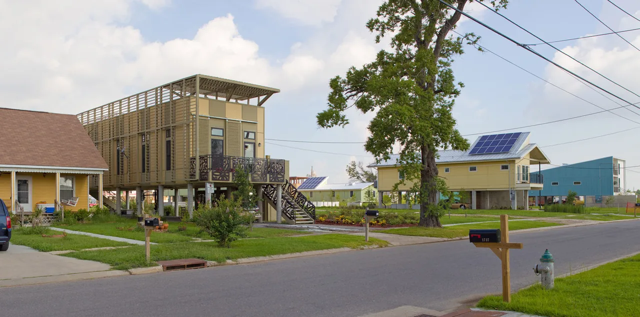 Special NO 9 House and neighboring homes elevated on concrete stilts with decorative metal railings in a residential setting.