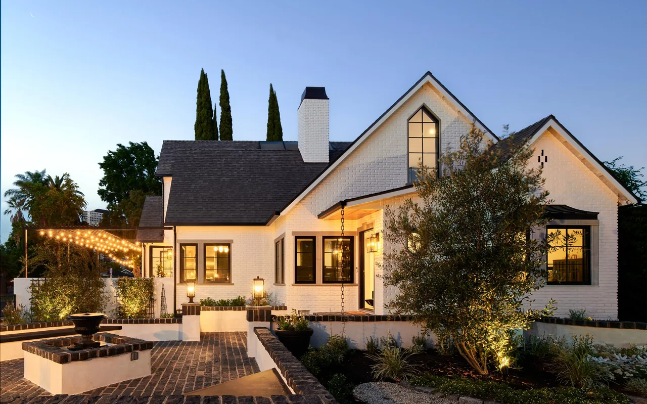 The Clybourn Manor features white brick exterior with black window frames and a gable roof design by Kurt Krueger Architect.
