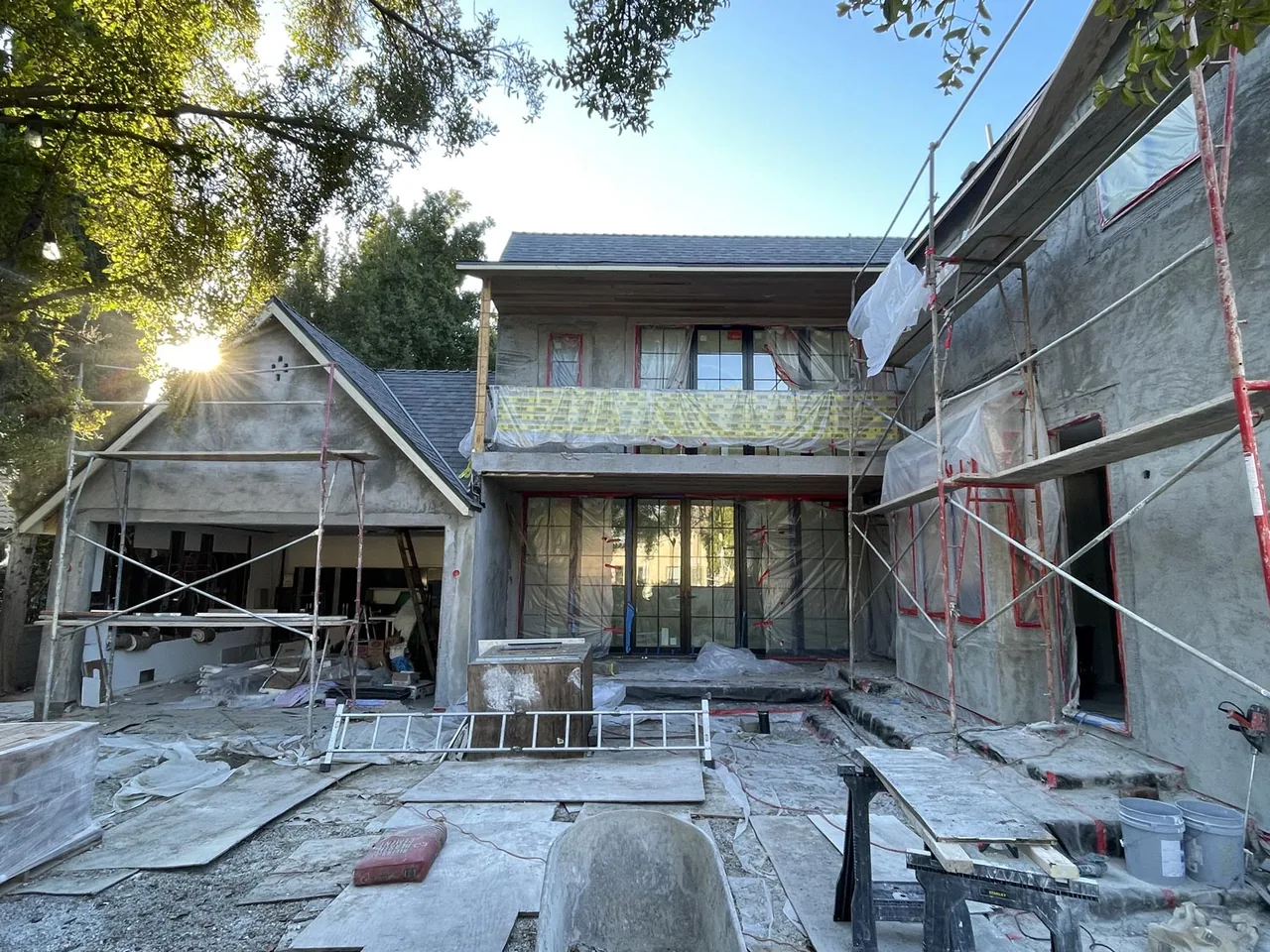 CLYBOURN MANOR house exterior under construction with scaffolding and covered openings.