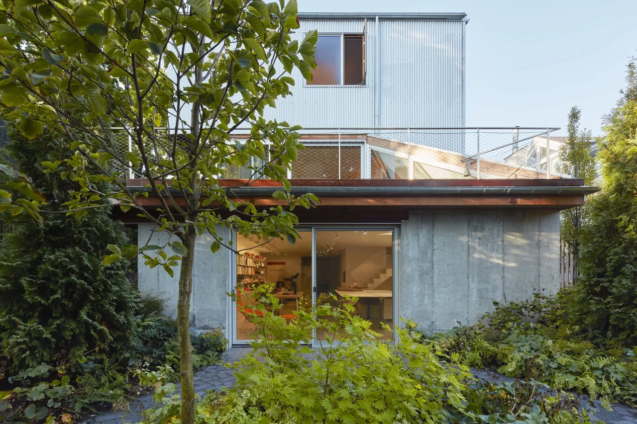 The exterior of House II features concrete and metal siding with a garden and sliding glass doors.