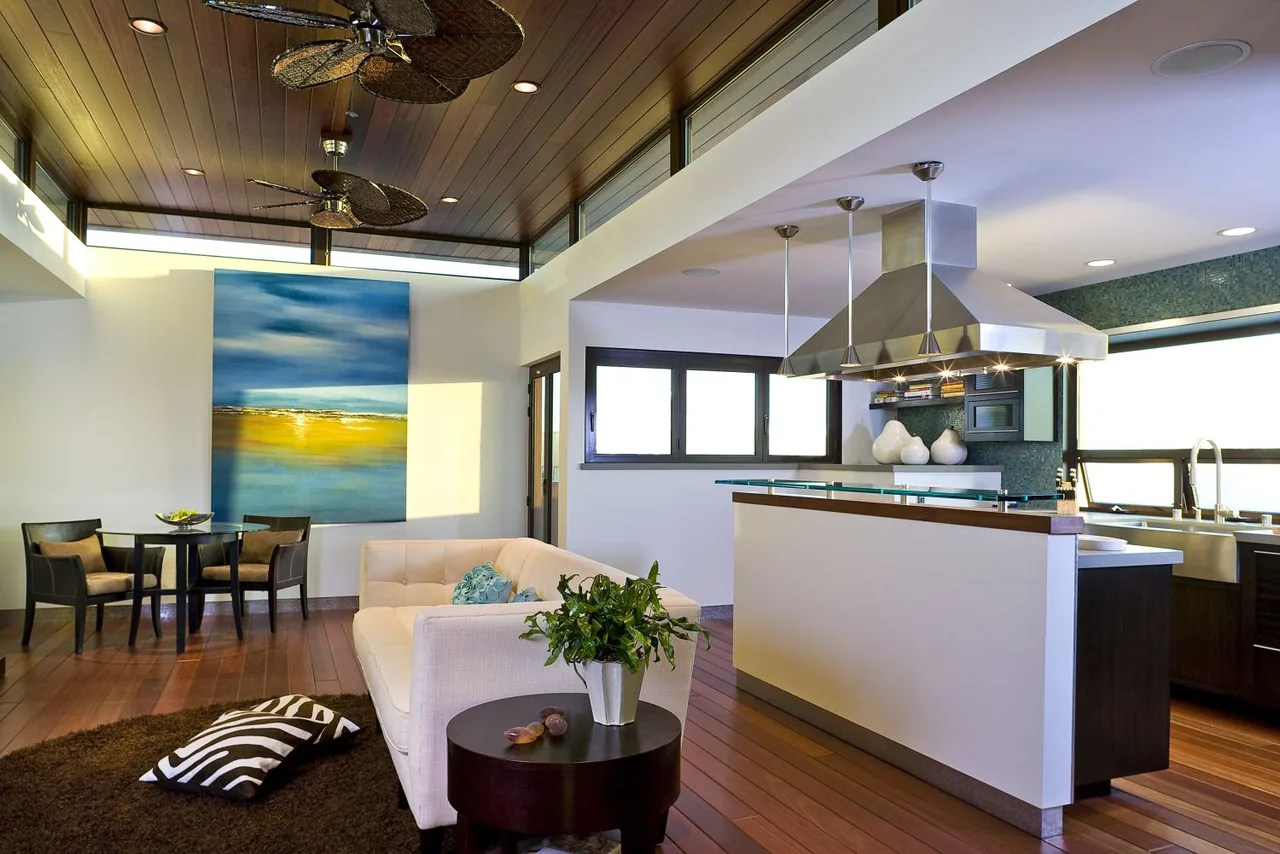 The 35th Street project features an open-plan living and kitchen area with a wood-paneled ceiling and ceiling fans.