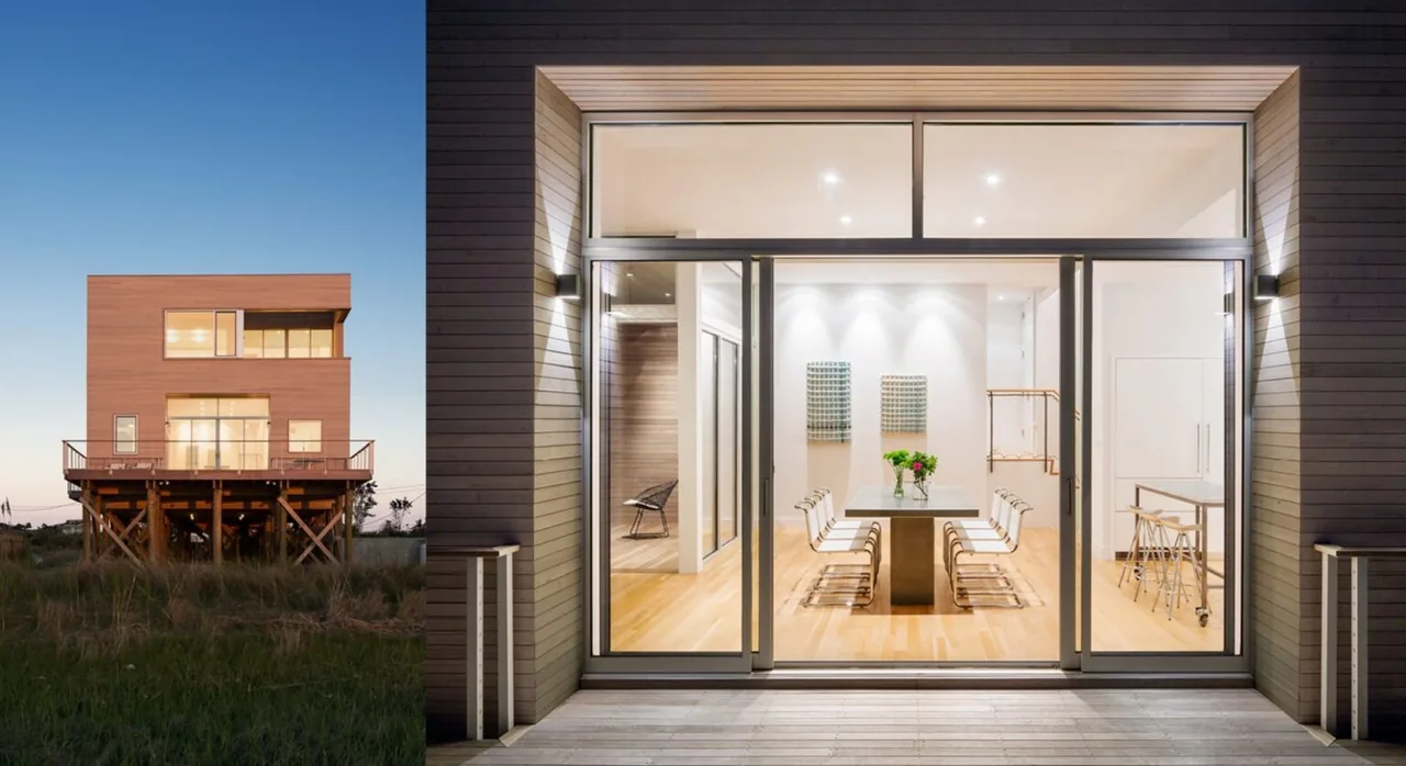 Cube House features a raised wood-clad exterior with rectangular clerestory windows and a balcony with cable railing.