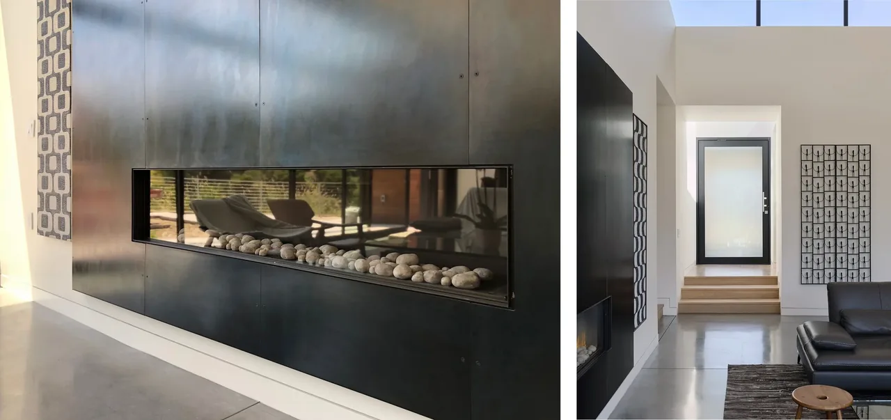 Living room with a black linear fireplace recessed in a dark metal wall panel, polished concrete floor, and modern furnishings.