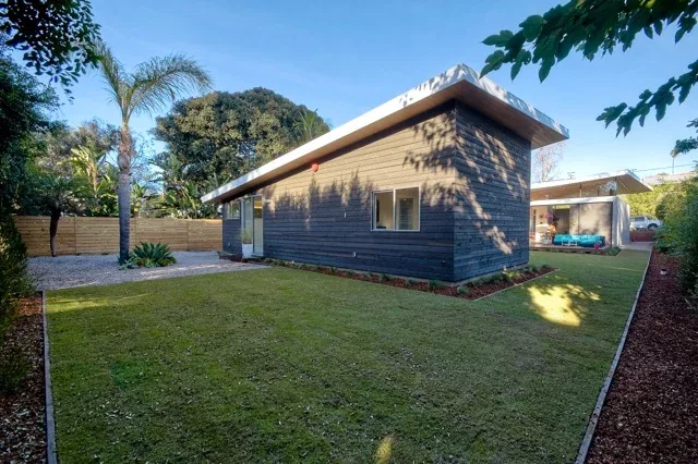 The Aa House by Lloyd Russell AIA features a flat roof and wood siding with a spacious lawn in San Diego.