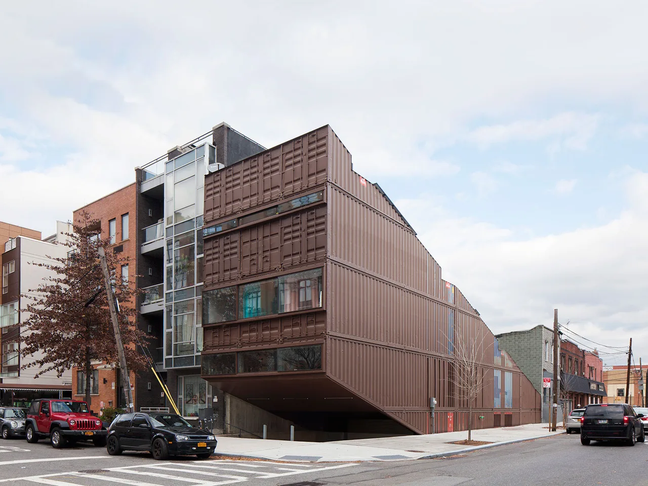 Carroll House by LOT-EK features a facade constructed from stacked shipping containers in an urban setting.