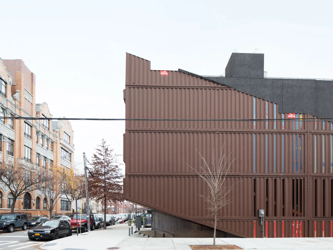 The Carroll House in New York features a distinctive shipping container facade and urban corner design.