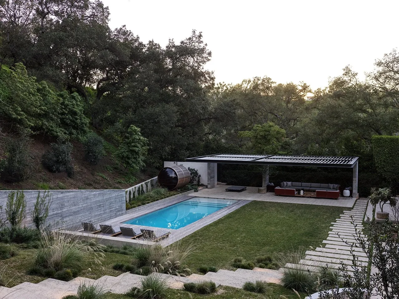 Outdoor living space featuring a pool, terrace, and shaded lounge at Canyon House, Los Angeles.
