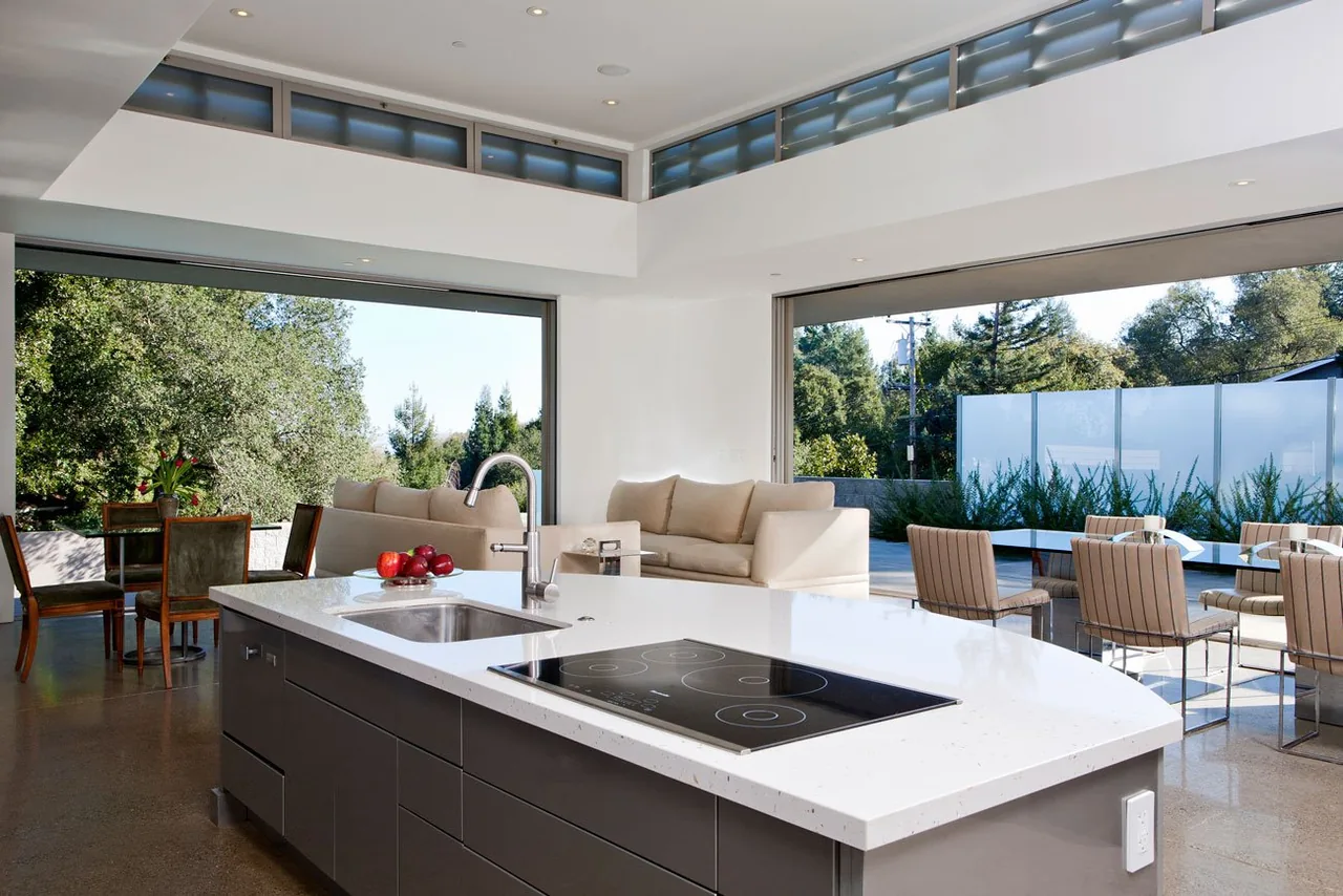 The Olson Residence features an open kitchen and living area that opens seamlessly to outdoor seating areas.