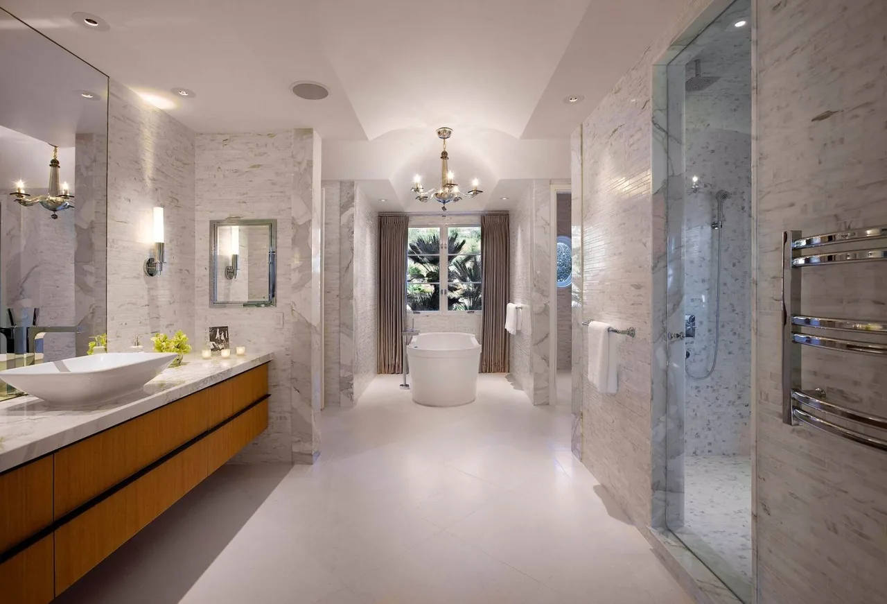 Spacious bathroom featuring a freestanding tub, walk-in shower, and wooden vanity under vaulted ceiling.
