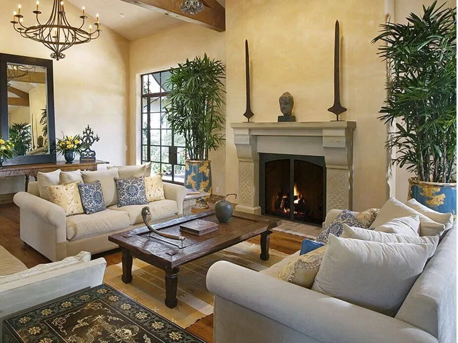 Spacious living room with vaulted ceiling, a stone fireplace, and large windows overlooking the outdoors.