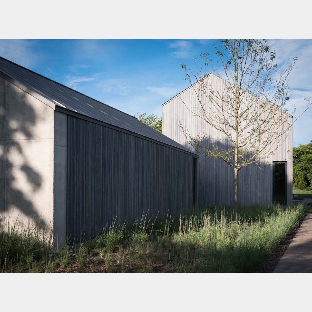 The house in the lanes features vertical wood siding and a simple gable roof design.