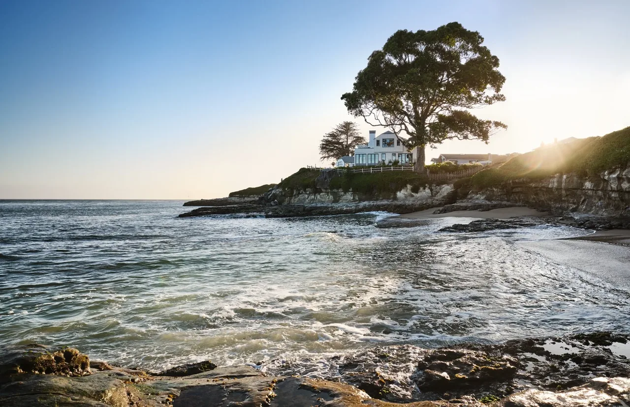 The Pacific Promontory house by McGriff Architects is perched on a rocky coastal point overlooking the ocean.