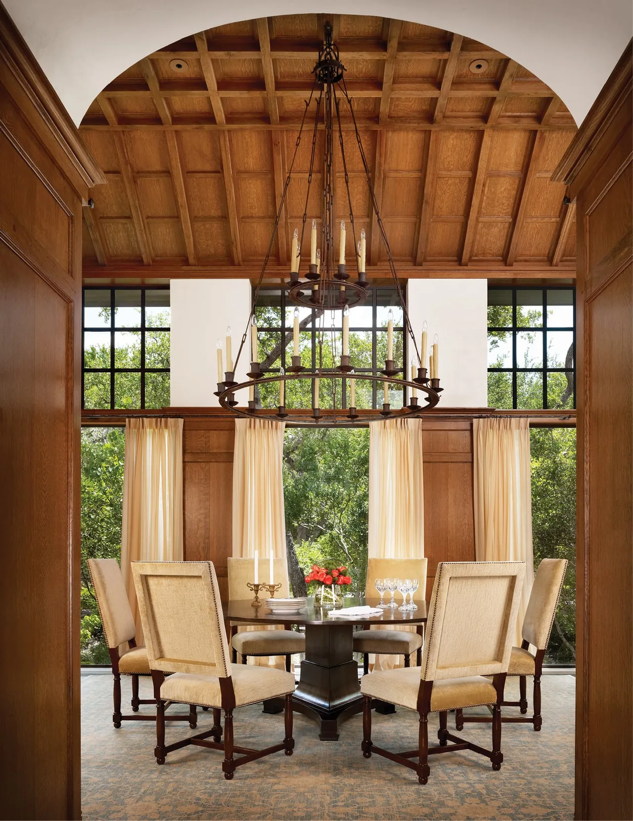 The Turnberry dining room features wood paneling, a coffered ceiling, and large black-framed windows.