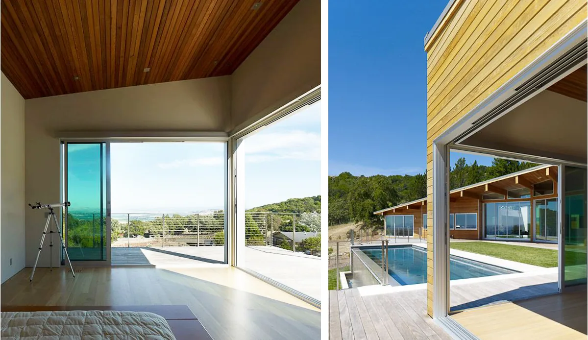 Modern residence features large sliding glass doors connecting bedroom interior with an outdoor pool deck clad in wood siding.