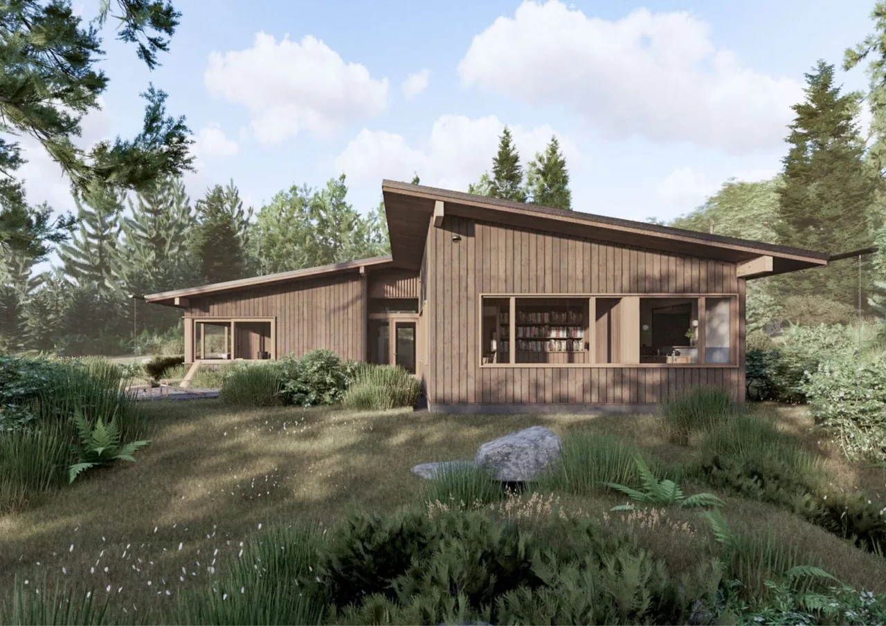 Whidbey Bluff House features wood siding and sloped roofs amid a lush, natural landscape with native plants and rocks.