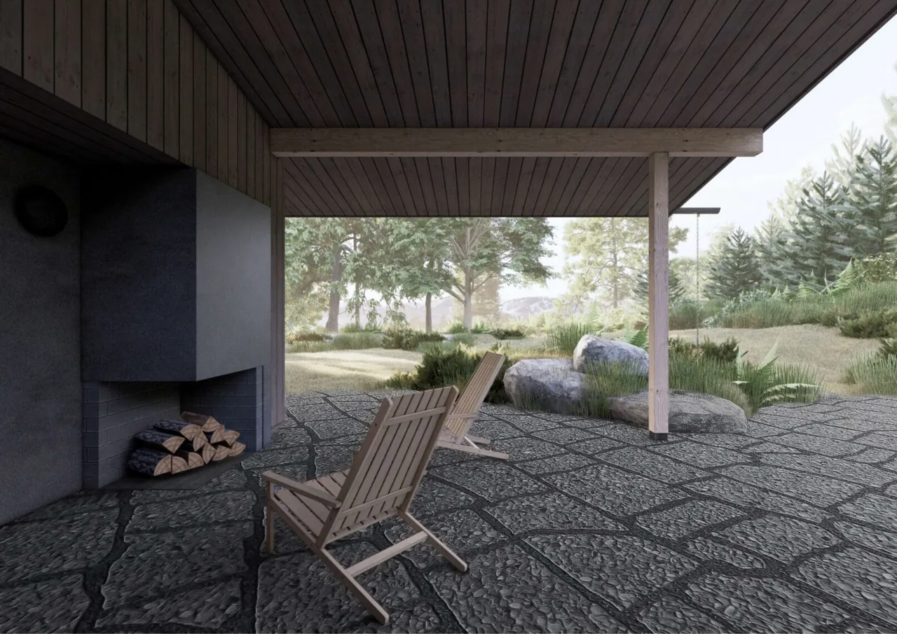 The covered patio of Whidbey Bluff House features textured stone flooring and a built-in fireplace, overlooking a natural landscape.