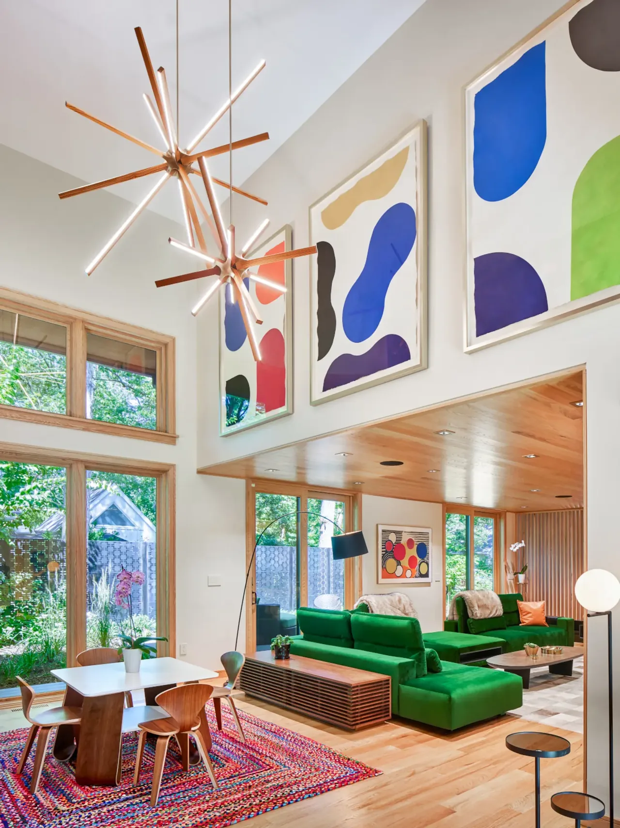Open living and dining area in the Tidewater project with modern furniture and bold artwork by Moto Designshop.