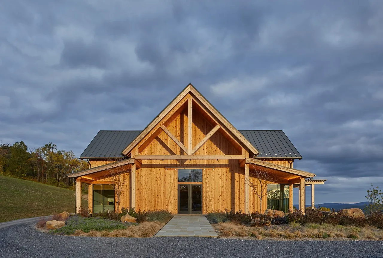 Crimson Lane Vineyard features timber framing and a triangular gable roof with metal standing seam roofing.