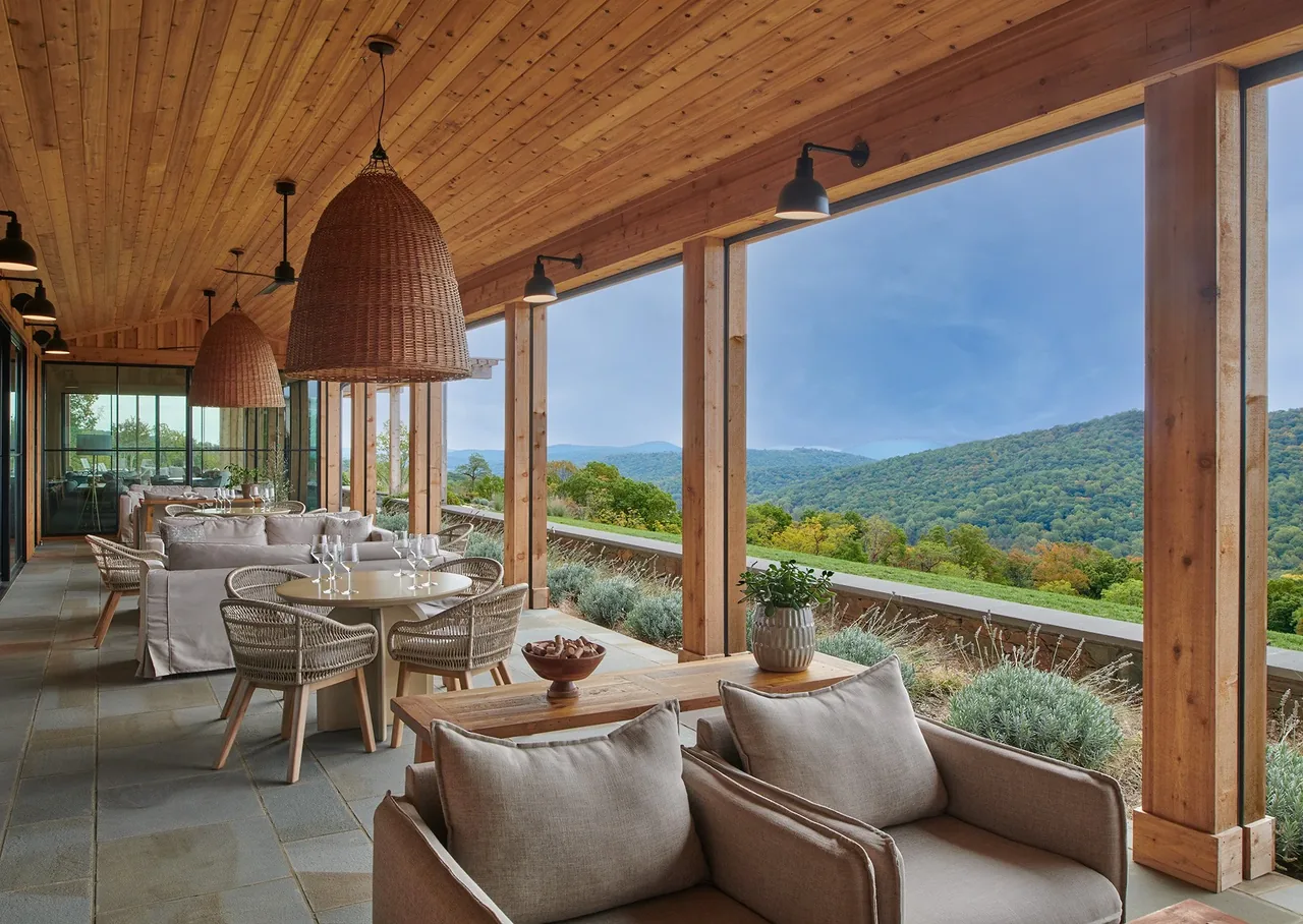 Outdoor covered patio at Crimson Lane Vineyard with cozy seating and views of the surrounding hills.